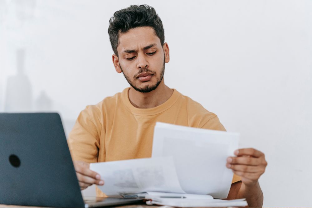 Man considering the disadvantages of a binding financial agreement.